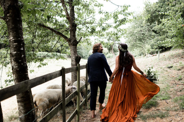 Newly married man and woman walking through the countryside