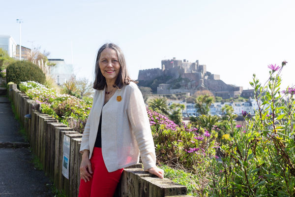 Melanie Cavey sat on wall overlooking castle