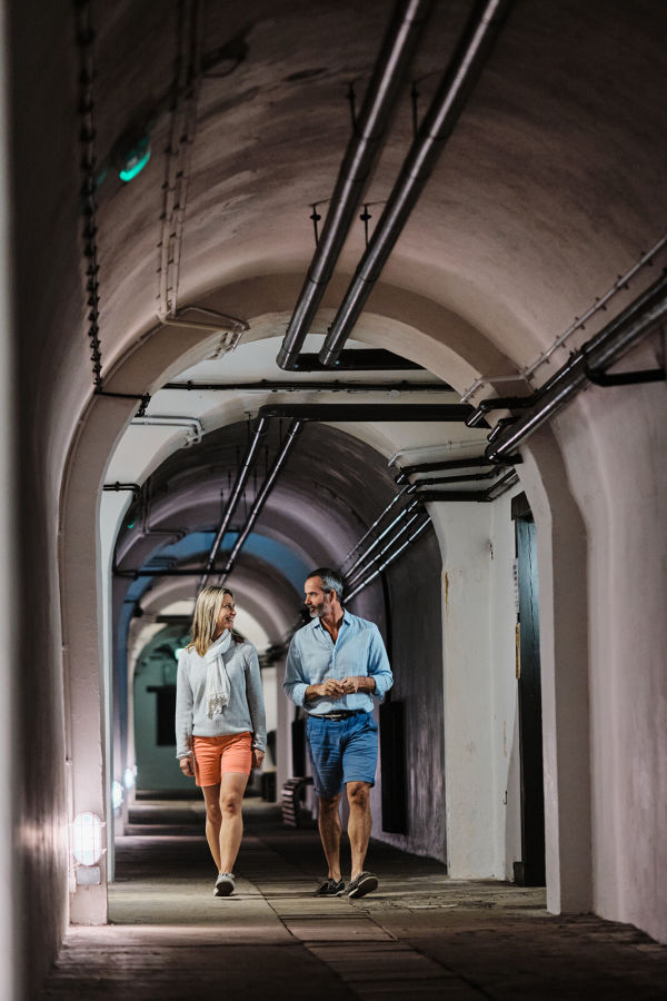 Couple walking through the Jersey War Tunnels.
