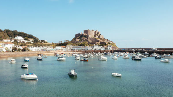 Boats moored in front of Mont Orgueil Castle
