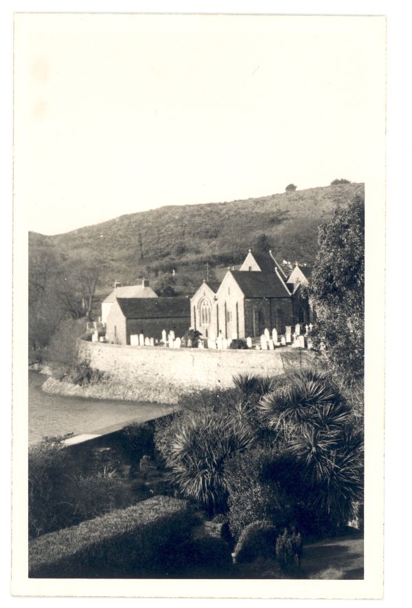 Black and white picture of a historic church next to a beach