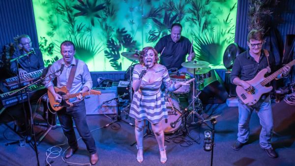 A rock band performing in a night-bar in St. Helier.