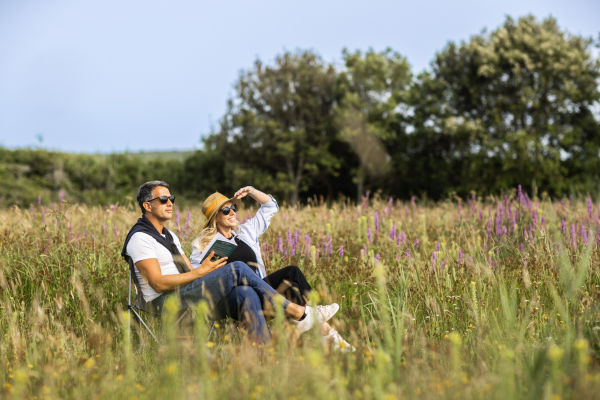 Couple sitting in a field of wildflowers