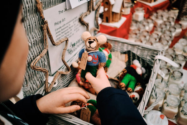 Child holding handcrafted teddy bear