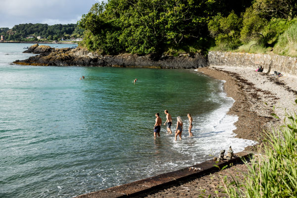group of couples wading into the water
