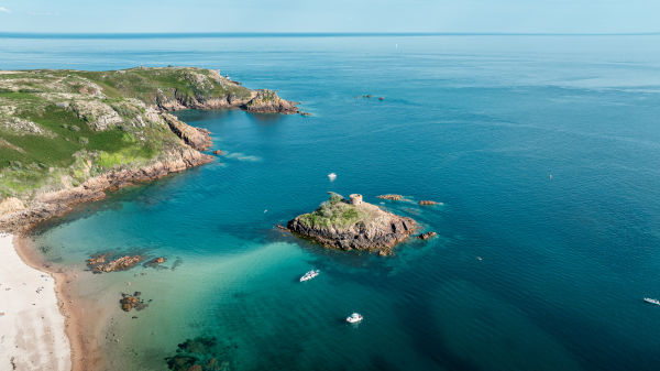 Aerial view of Portelet Bay, Jersey, with its turquoise sea and golden sand