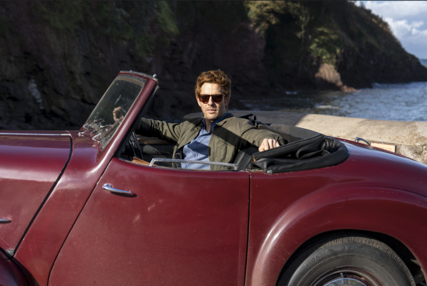 Bergerac star Damien Molony poses in the burgundy Triumph Roadster which appeared in the original Bergerac series