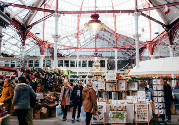 People walking around the central market in Saint Helier