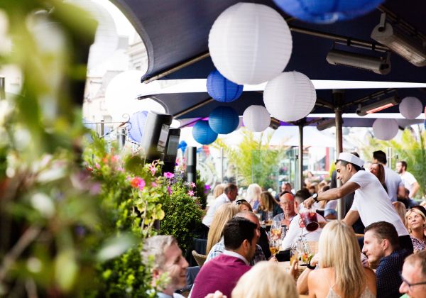 People enjoying a drink outside at Cafe Zephyr