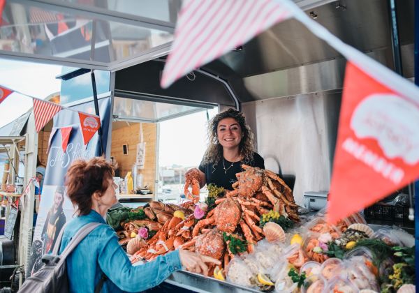 Girl at a fish counter selling seafood