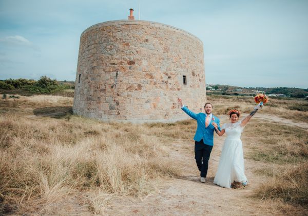 Just married couple in front of a historic coastal fort