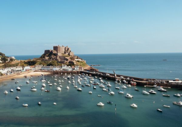 Fishing boats in Gorey harbour at high tide with Mont Orgueil Castle in the background