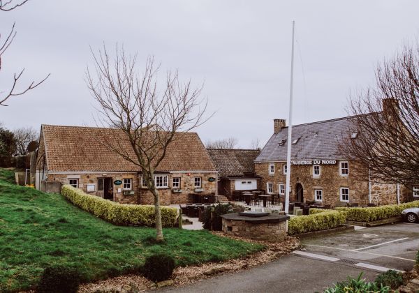 A picture of a rustic, traditional English Country Pub with a granite floor beer garden.