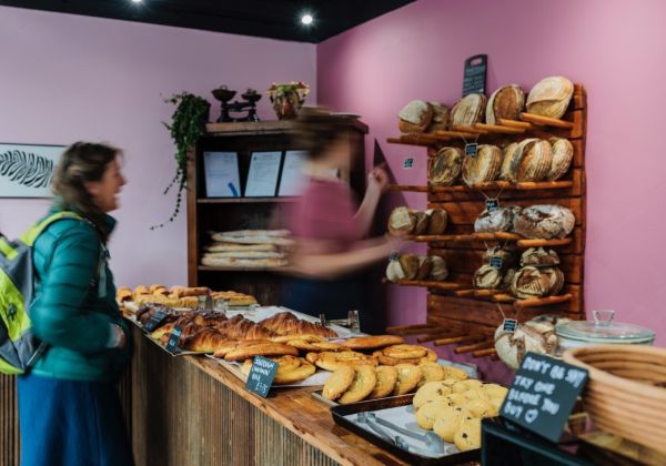 Woman serving a customer at a bakery