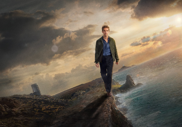 Damien Molony as Berrgerac walking along a cliff edge with the Radio Tower and Le Pinacle in the background.