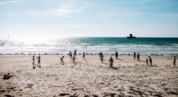 People playing on the sand at St. Ouen
