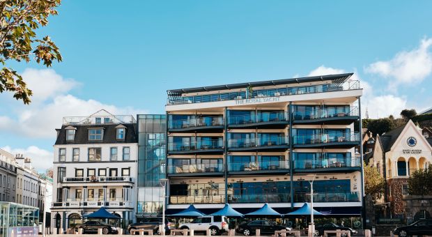 Modern hotel next to an older hotel with blue skies
