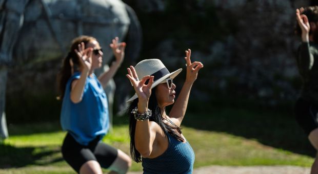 People doing yoga outside
