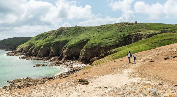 Couple walking along the Jersey Tidal Trail, Plemont Jersey