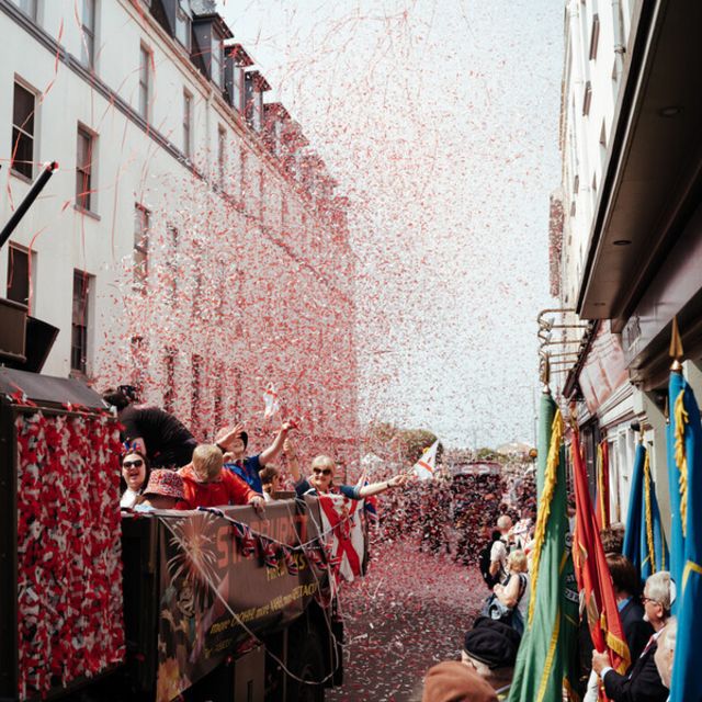 Colourful confetti cannons exploding over crowd