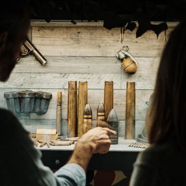 People looking at the displays in the Jersey War Tunnels.