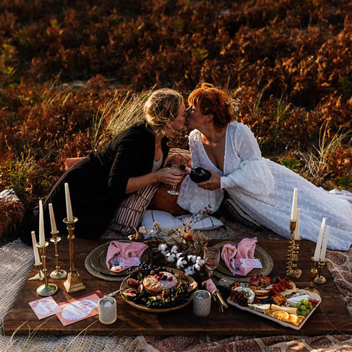 A couple having a romantic picnic for their wedding