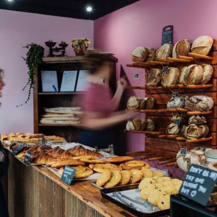 Woman serving a customer at a bakery