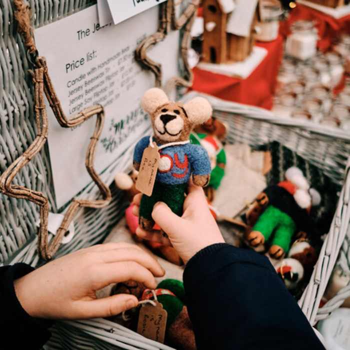 Child holding handcrafted teddy bear