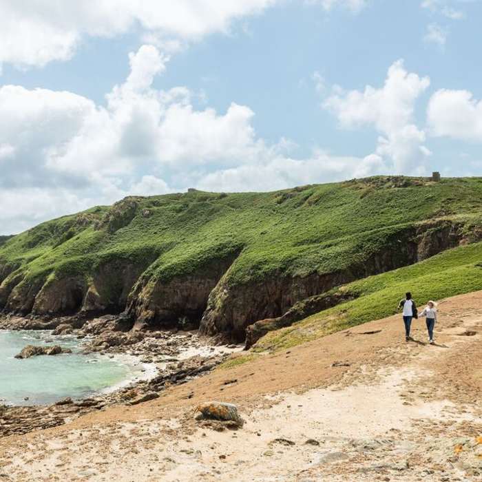 Couple walking along the Jersey Tidal Trail, Plemont Jersey